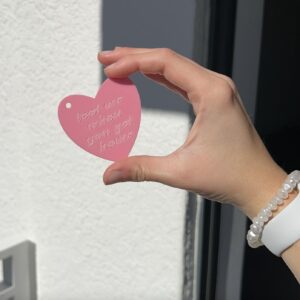 heart key chain that says "text me when you get home" held up by a hand