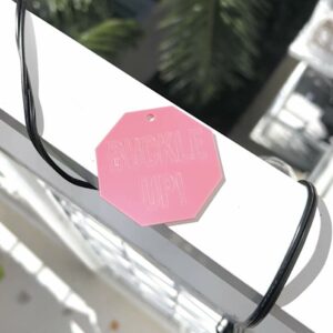 pink octagon key chain that says "BUCKLE UP!"